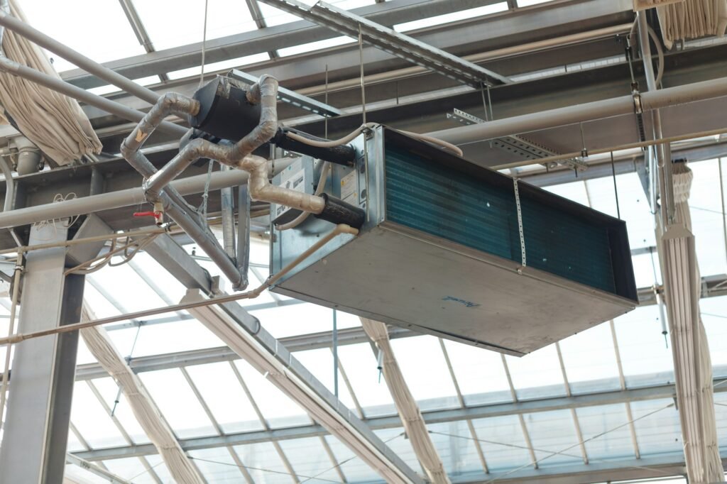 Commercial HVAC unit and ductwork hanging from a ceiling